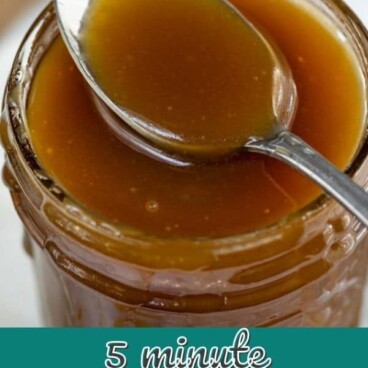 Overhead shot of salted caramel sauce in a mason jar with a spoon