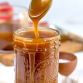 spoon above jar of caramel dripping caramel back into jar.