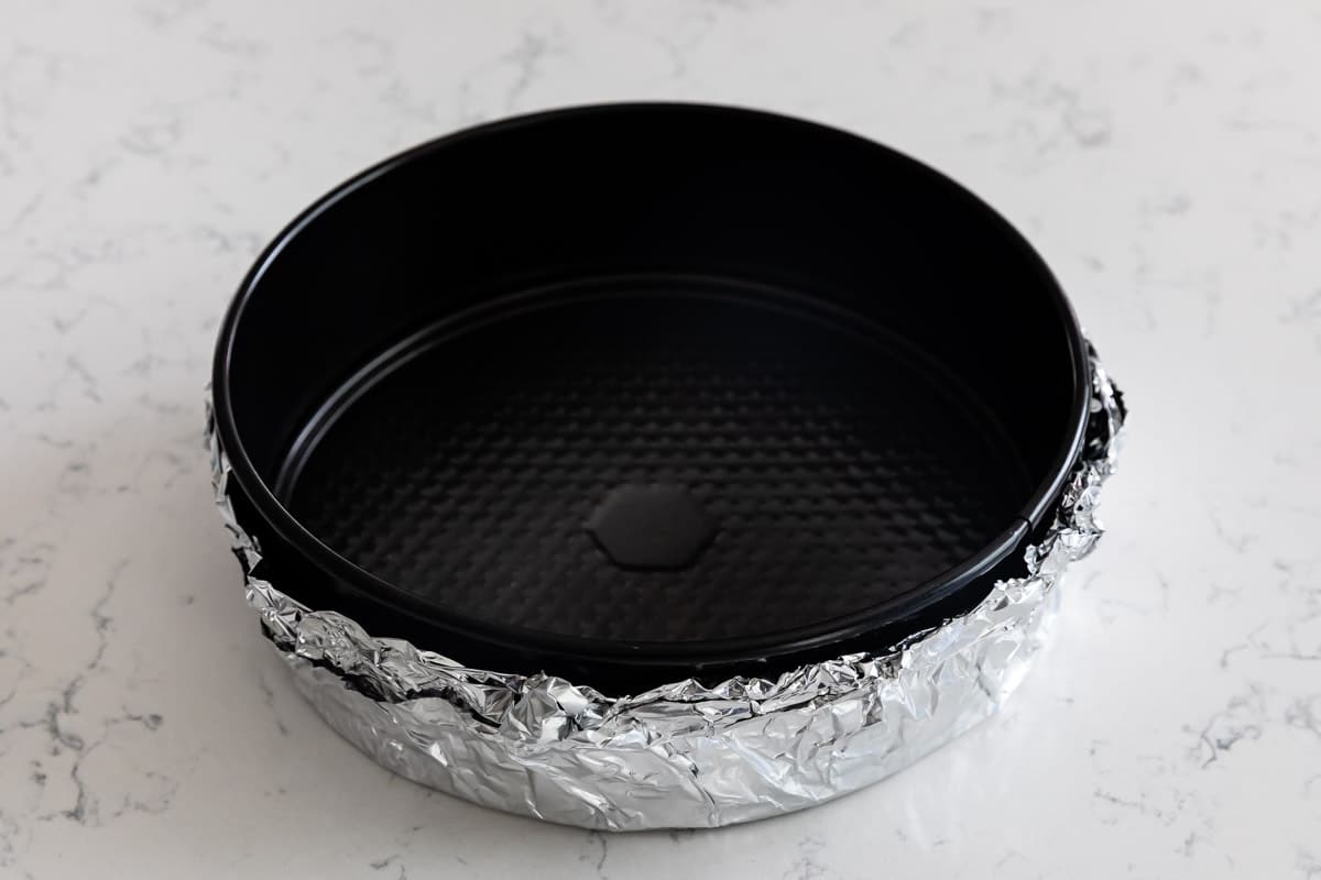 springform pan with foil around the edge