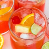 Overhead shot of three glasses of fruity vodka party punch