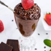 Avocado chocolate mousse in a glass pudding cup with a strawberry on top