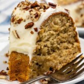 Slice of banana bundt cake on a plate with a silver fork