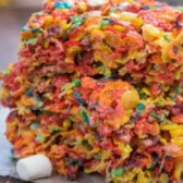 Two fruity pebble krispie treats stacked on eachother