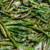 Roasted garlic green beans on a baking sheet with foil