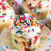 unwrapped funfetti cupcake on cupcake liner with sprinkles