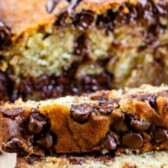 Loaf of chocolate chip banana bread with two slices cut off