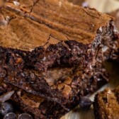 Stack of brown butter brownies with chocolate chips around them