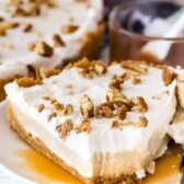 Slice of no bake butterscotch pudding pie on a plate with one bite missing