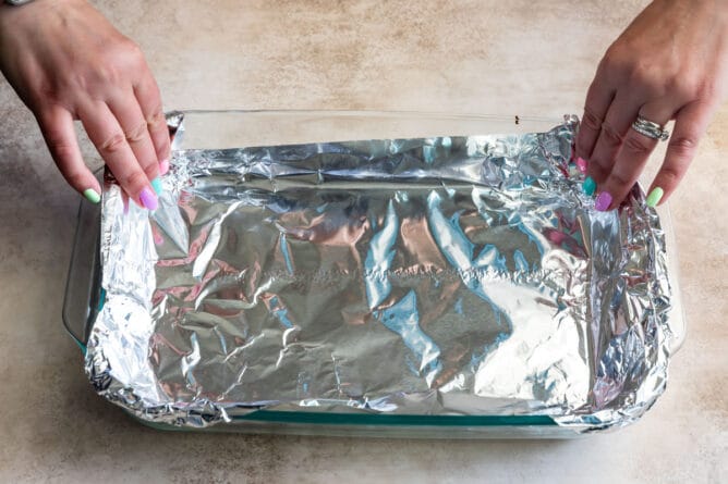 https://www.crazyforcrust.com/wp-content/uploads/2021/04/how-to-line-a-pan-with-foil-3-668x445.jpg