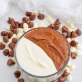 Overhead shot of white and milk chocolate chips with melted chocolate