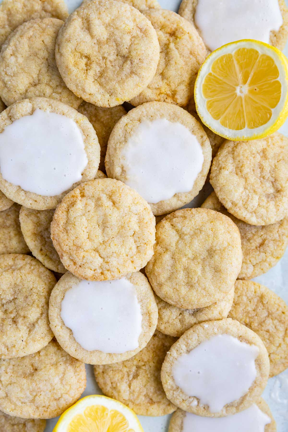 Overhead shot of lemon cookies mixed with lemon slices and iced lemon cookies