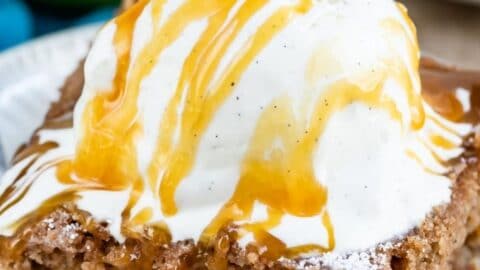 Slice of apple pie cake topped with ice cream and recipe title on top of image