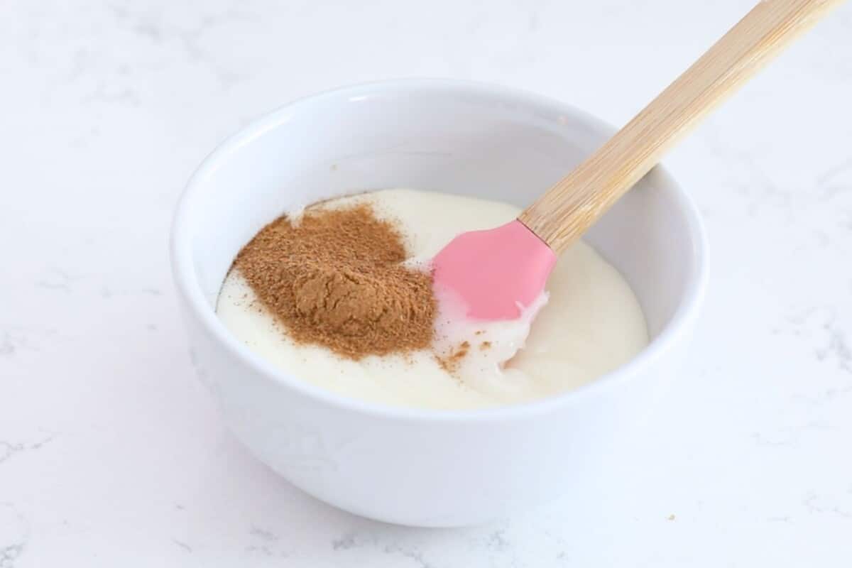 icing and spice in white bowl with spatula.