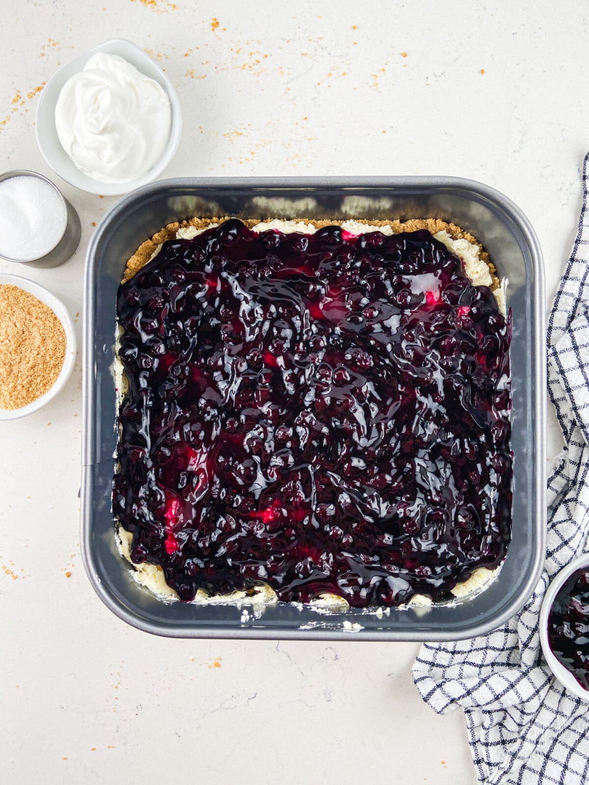 pan with blueberry pie filling on top.