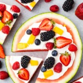 watermelon pizza on grey board with berries around