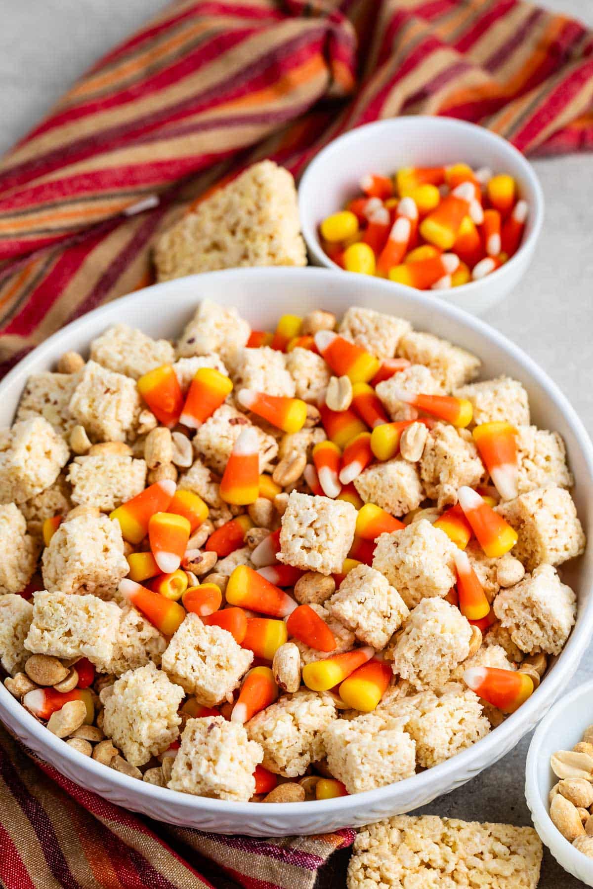 white bowl of snack mix with napkin behind