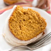 pumpkin bundt cake with frosting on top in a white platter