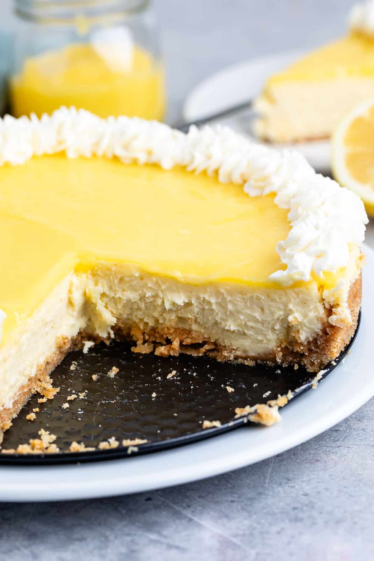 lemon cheesecake with slice missing on plate.