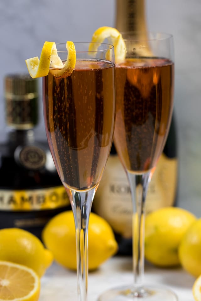 Kir royale champagne with a lemon peel on the rim