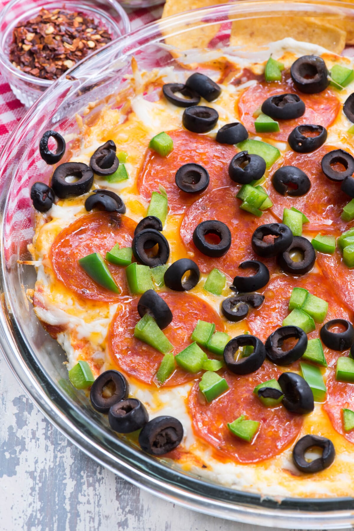 pizza dip with 7 layers of olives pepperoni cheese and sauce