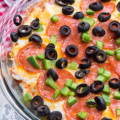 pizza dip with 7 layers of olives pepperoni cheese and sauce