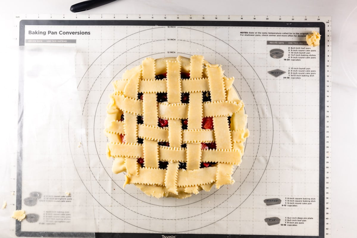 unbaked lattice pie on work surface.