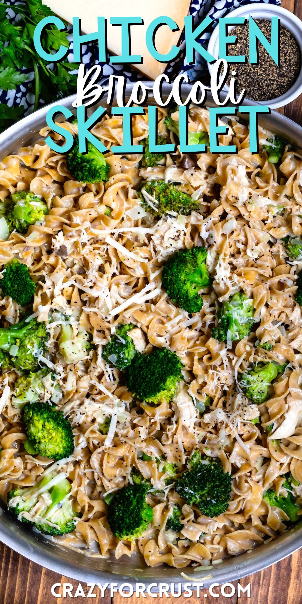 pasta mixed with broccoli in a silver skillet with words on the image.