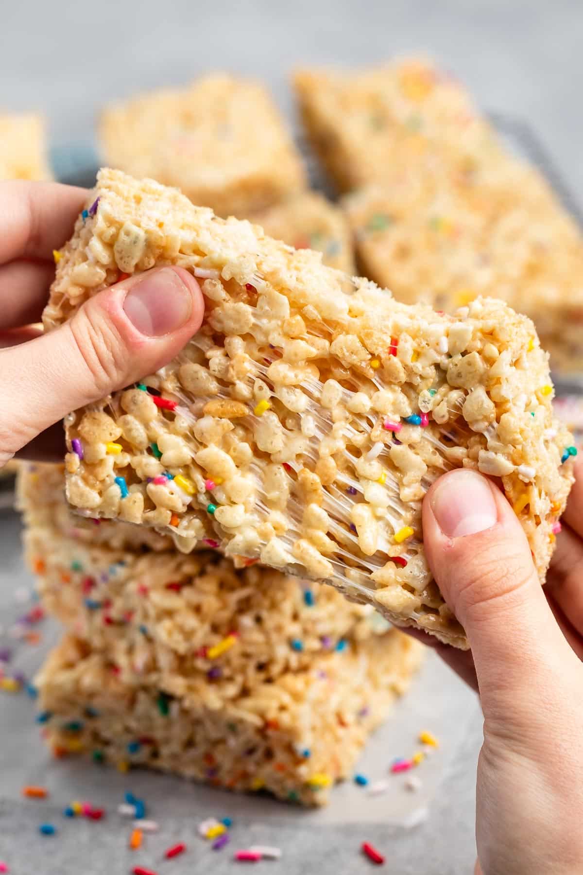 hand holding Rice Krispie treats with sprinkles baked in.