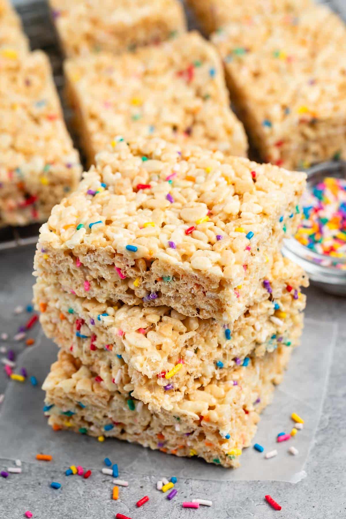 stacked Rice Krispie treats with sprinkles mixed in.