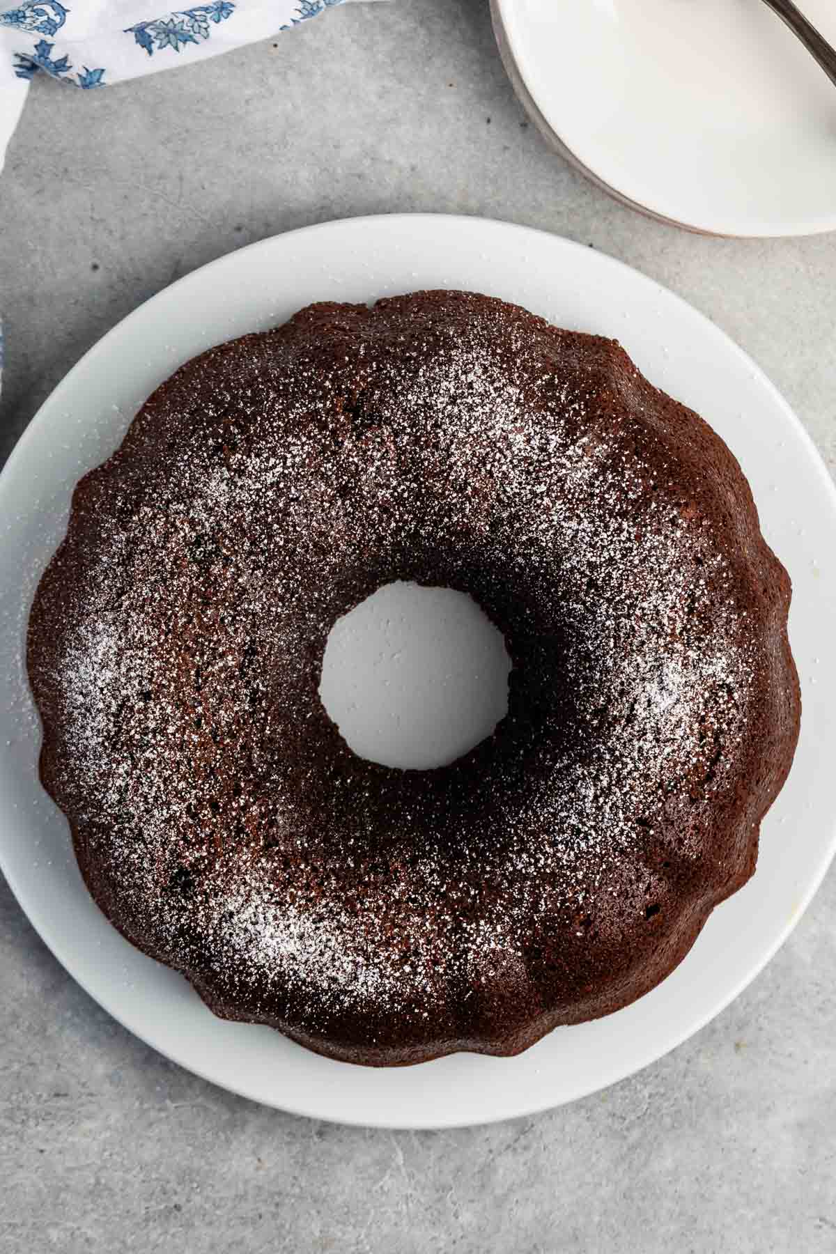 overhead shot of chocolate bundt cake with powdered sugar on top.