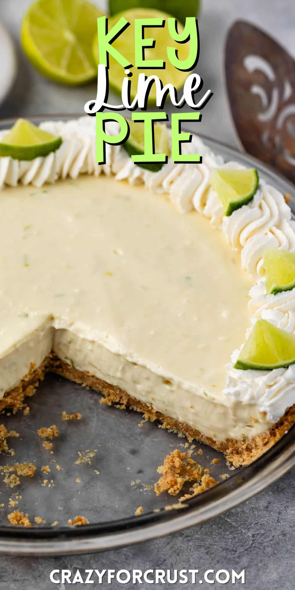 key lime pie with whipped cream and sliced limes on top with words on the image.