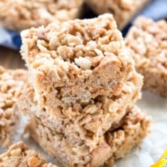 stacked Rice Krispie treats with butterfingers spread around.