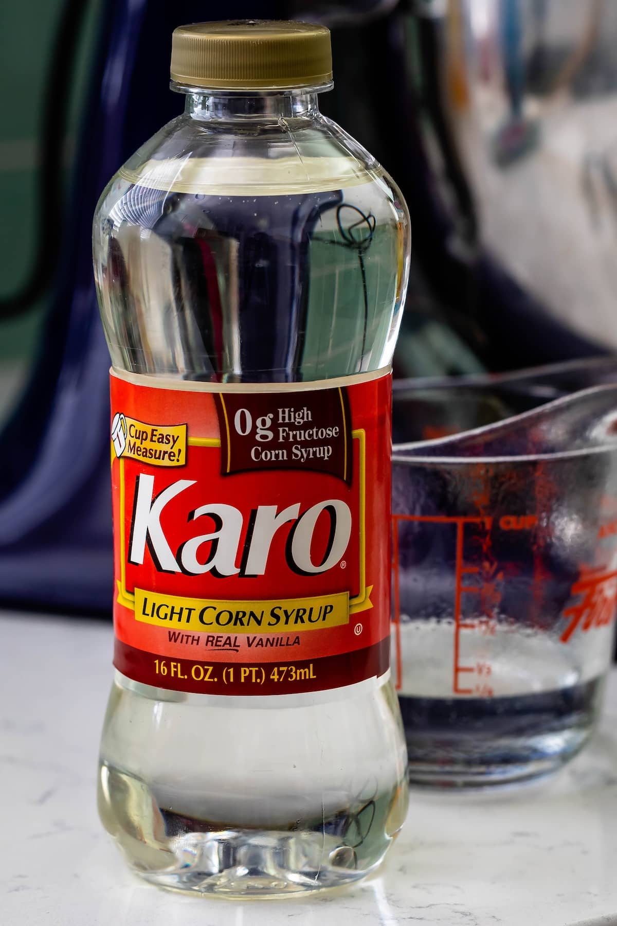 bottle of karo light corn syrup sitting on a white counter.