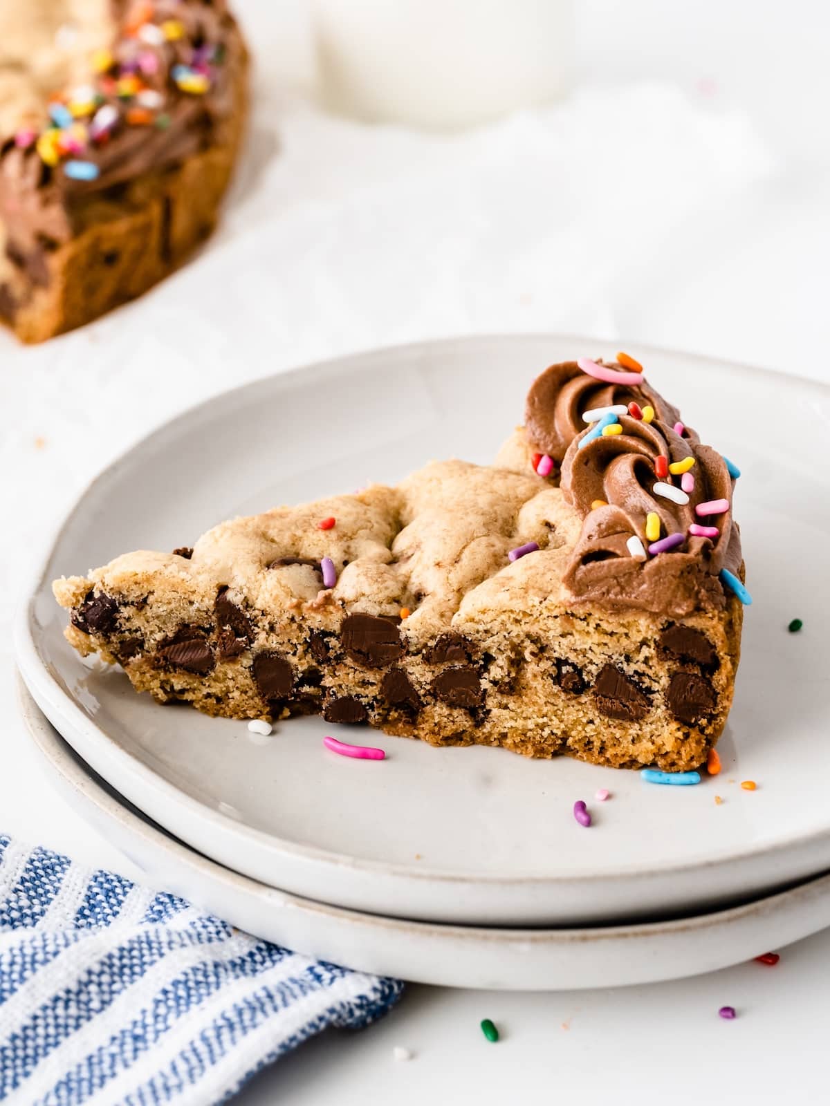 giant chocolate chip cookies with chocolate frosting and sprinkles on top.