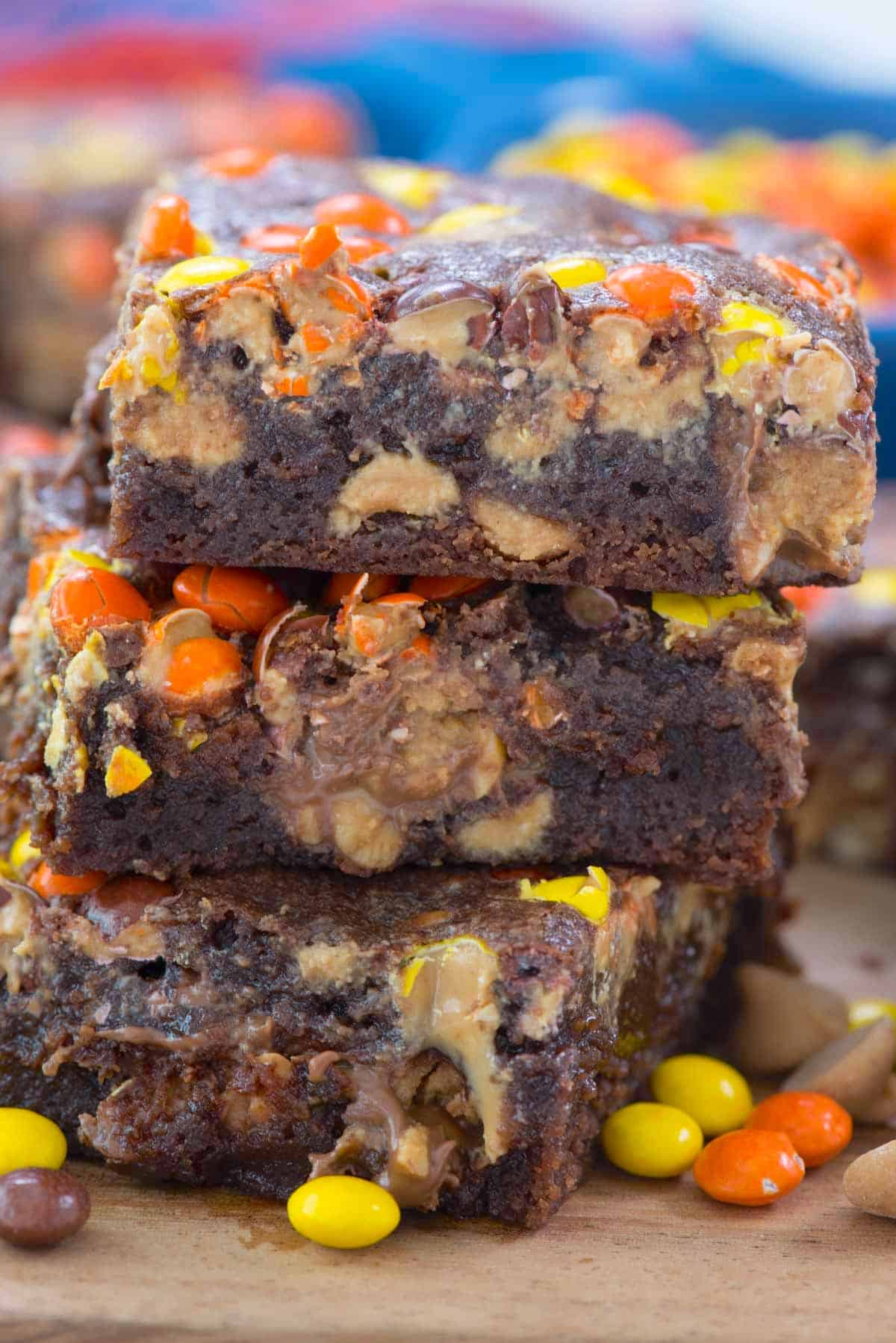 stacked brownies with yellow and orange reeses pieces baked inside.