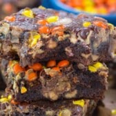 stacked brownies with yellow and orange reeses pieces baked inside.