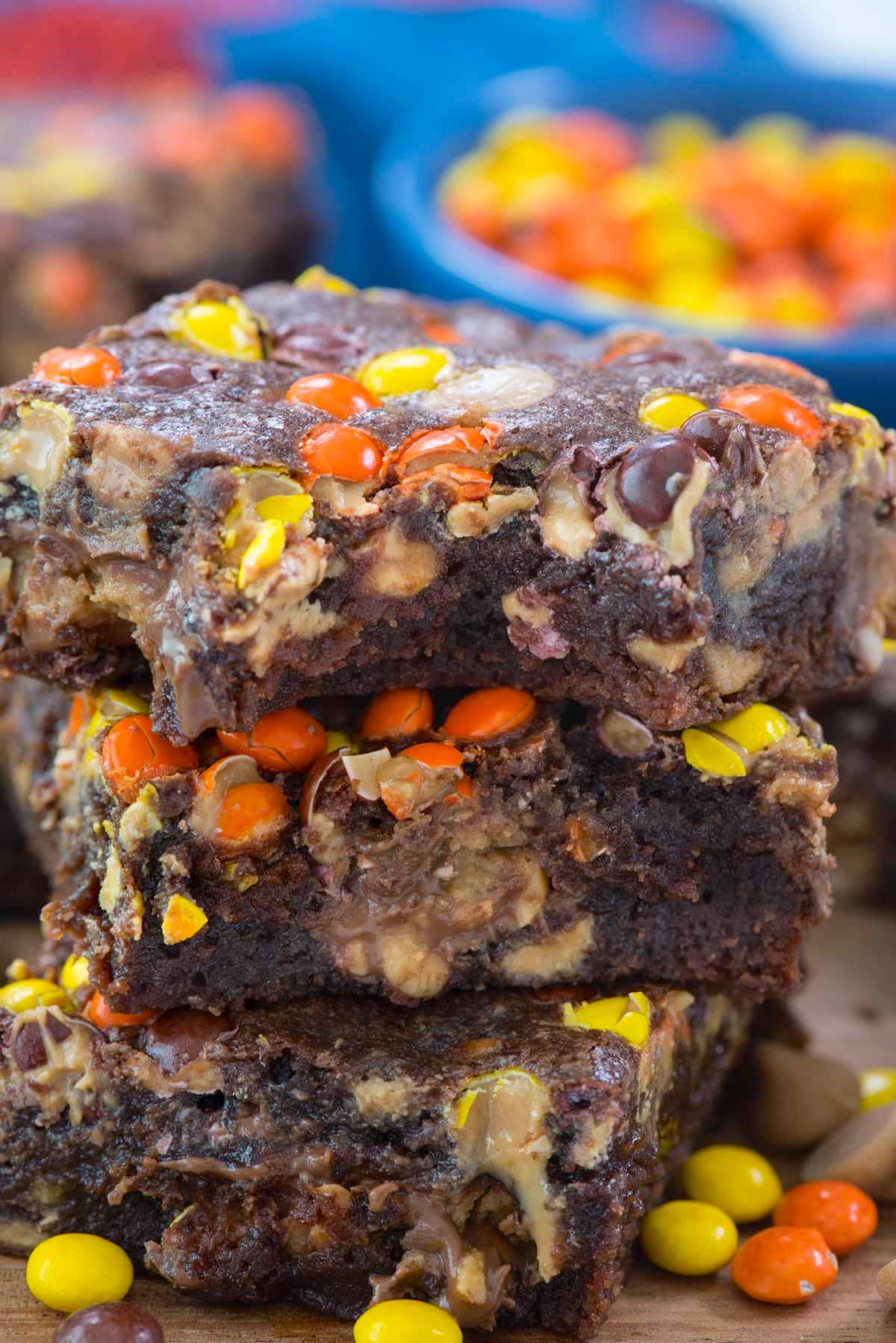 stacked brownies with yellow and orange reeses pieces baked inside.