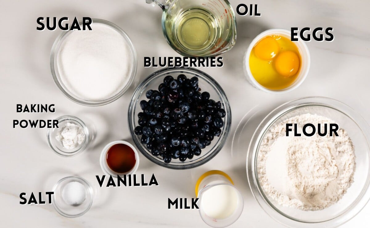 ingredients in blueberry bread laid out on a white counter.