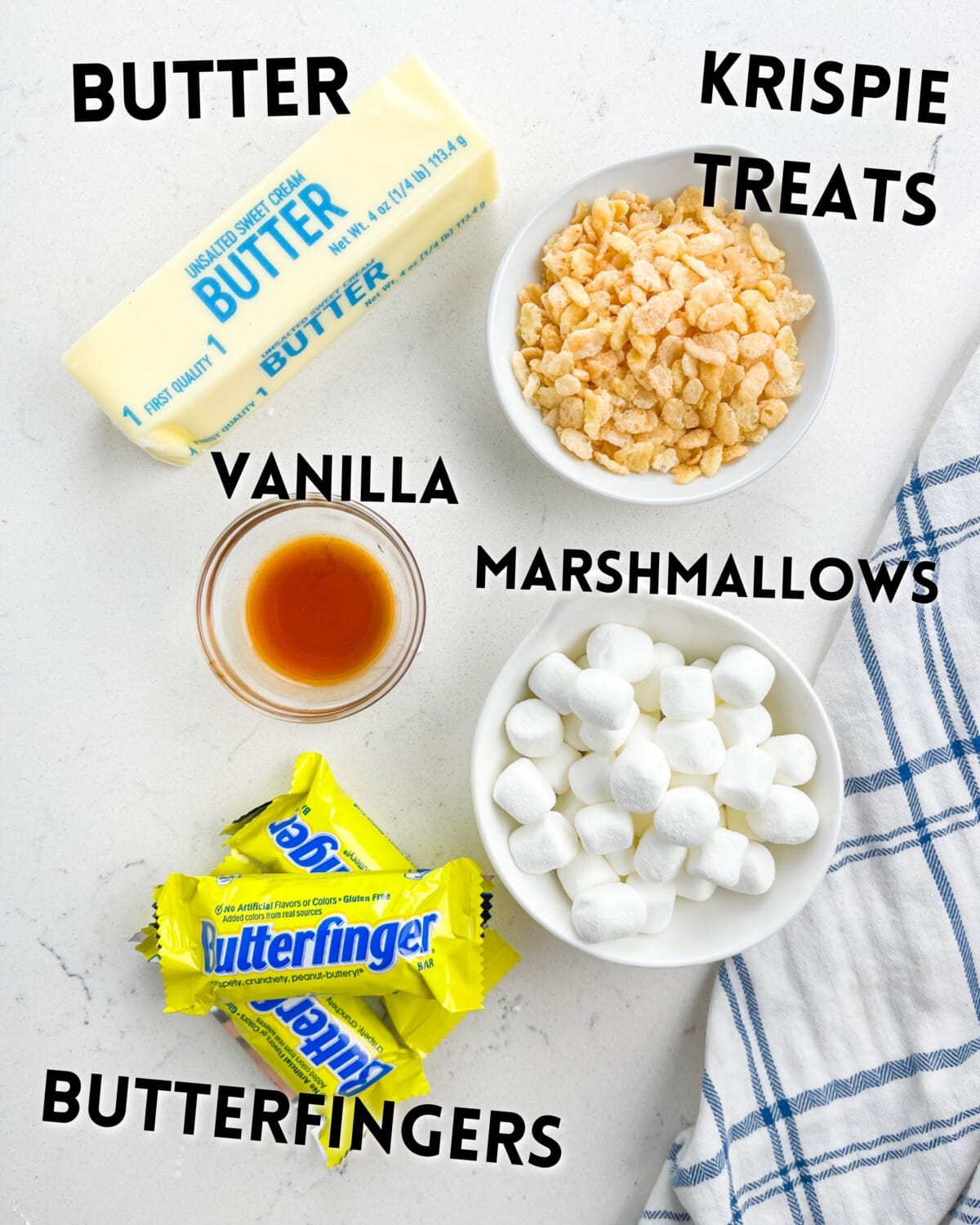 ingredients in butterfinger Krispie treats laid out on a white counter.