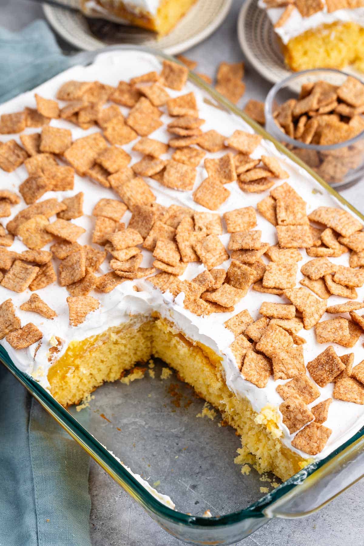 cake with white frosting and cinnamon toast crunch on top.