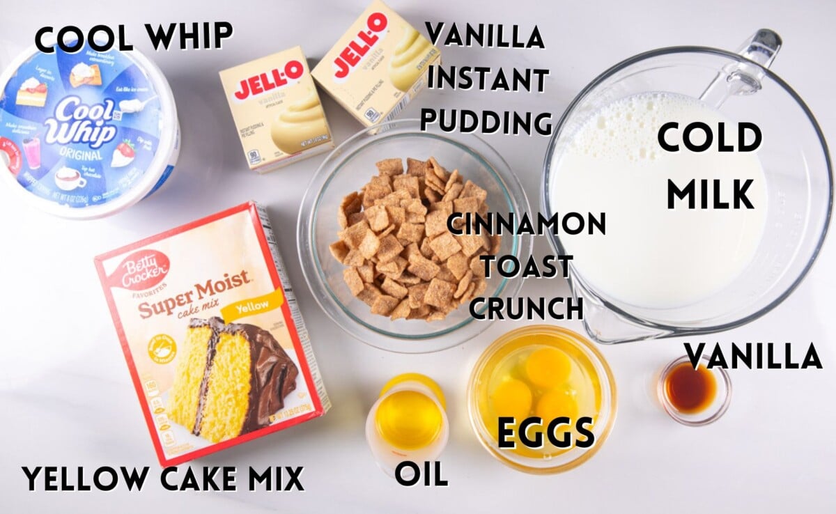 cereal milk poke cake ingredients laid out on a white marble counter.