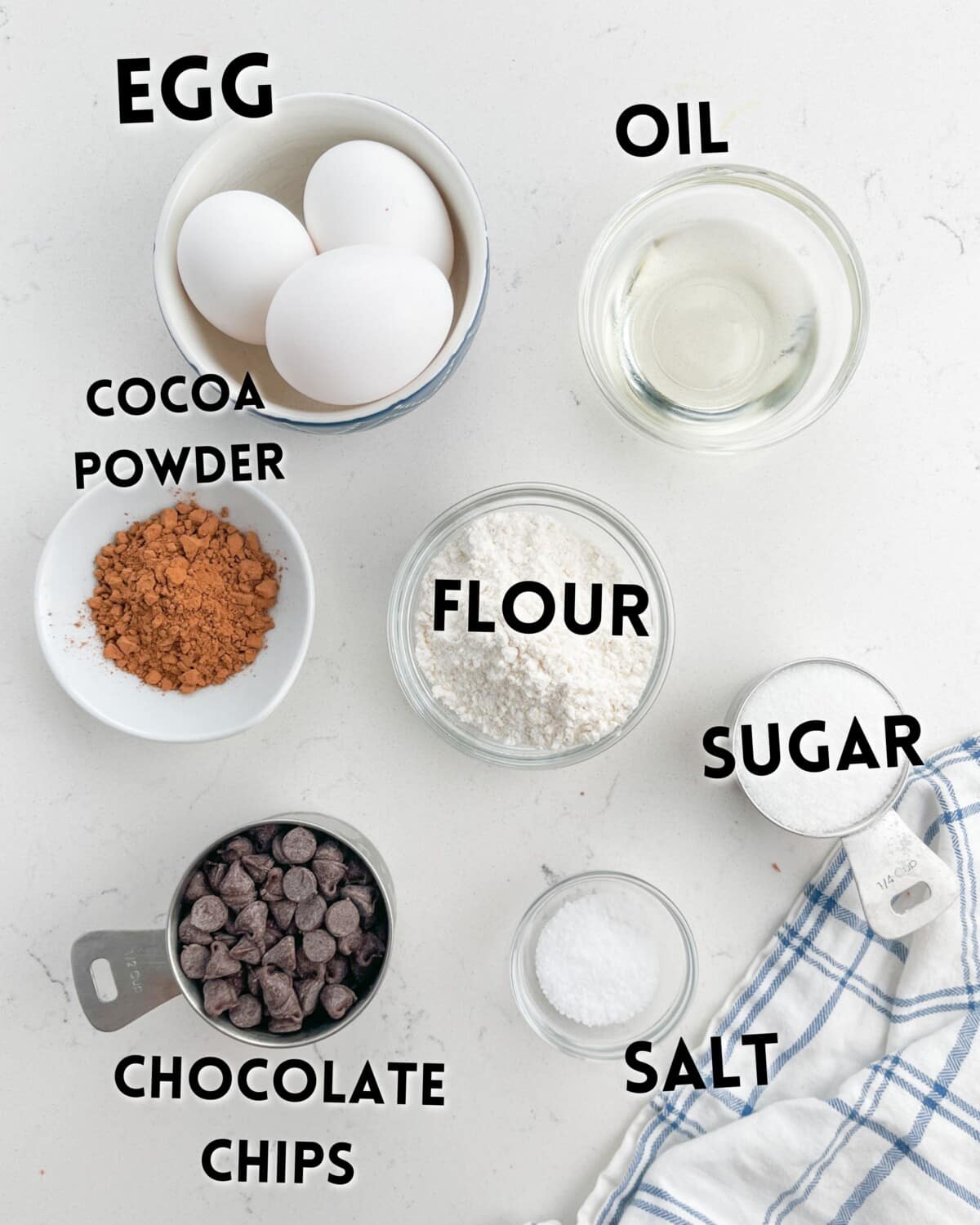 ingredients in fudgy brownies laid out on a white counter.