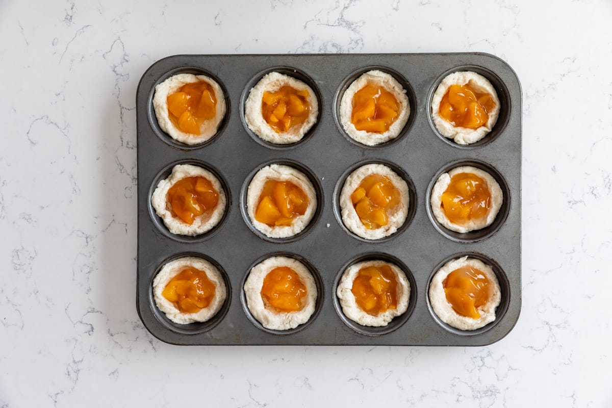 process shot of peach danishes being made.