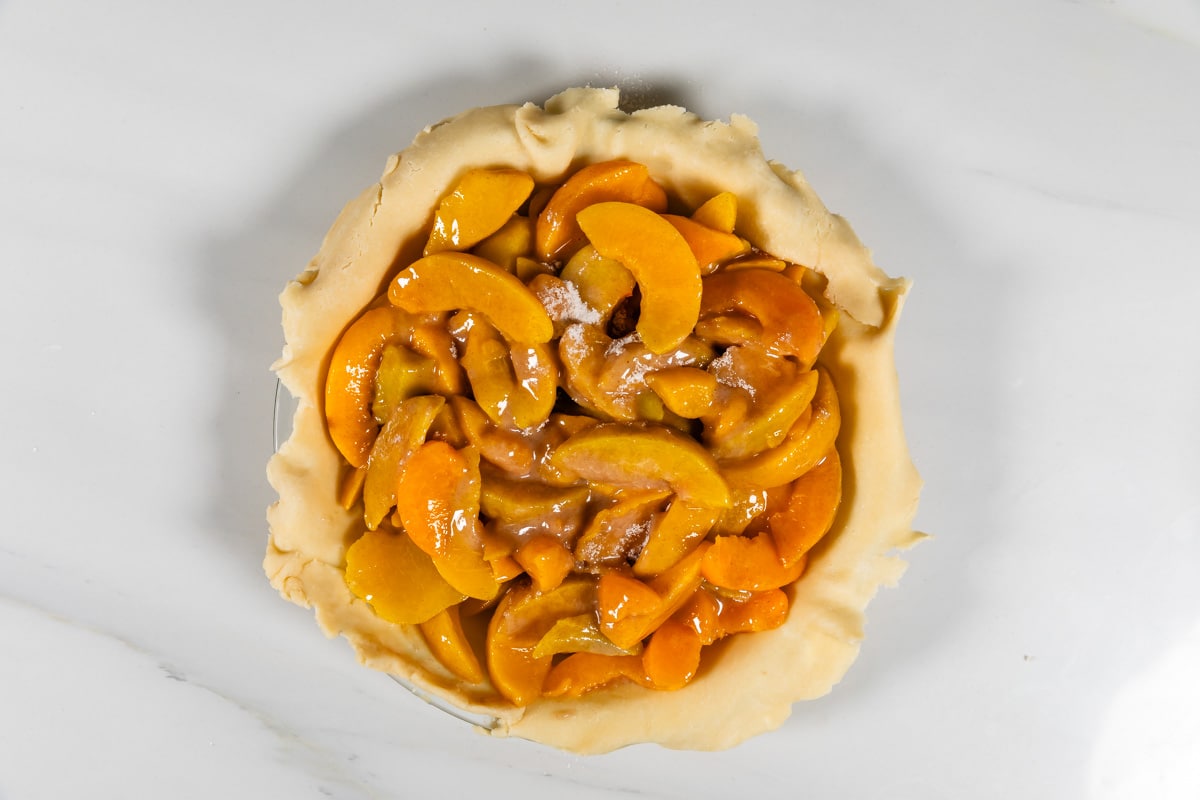 process shot of peach pie being made.