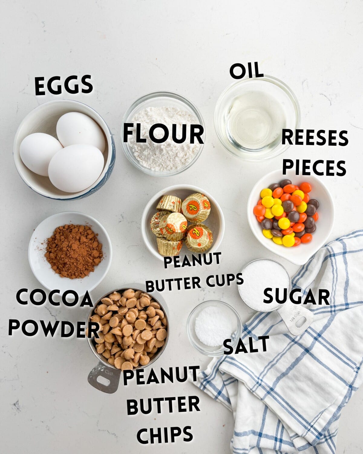 ingredients in reeses brownies laid out on a white marble countertop.