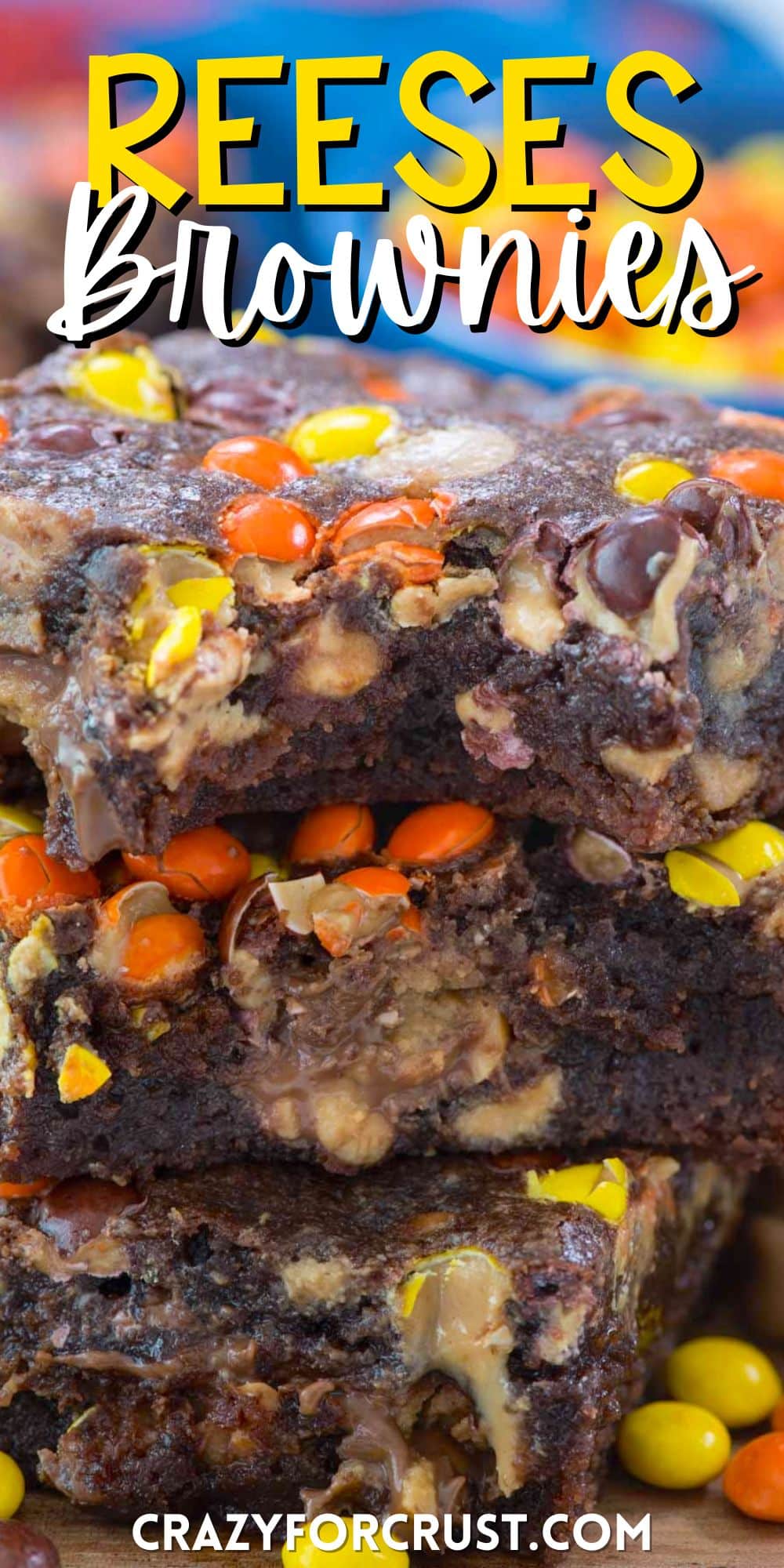 stacked brownies with yellow and orange reeses pieces baked inside with words on the image.