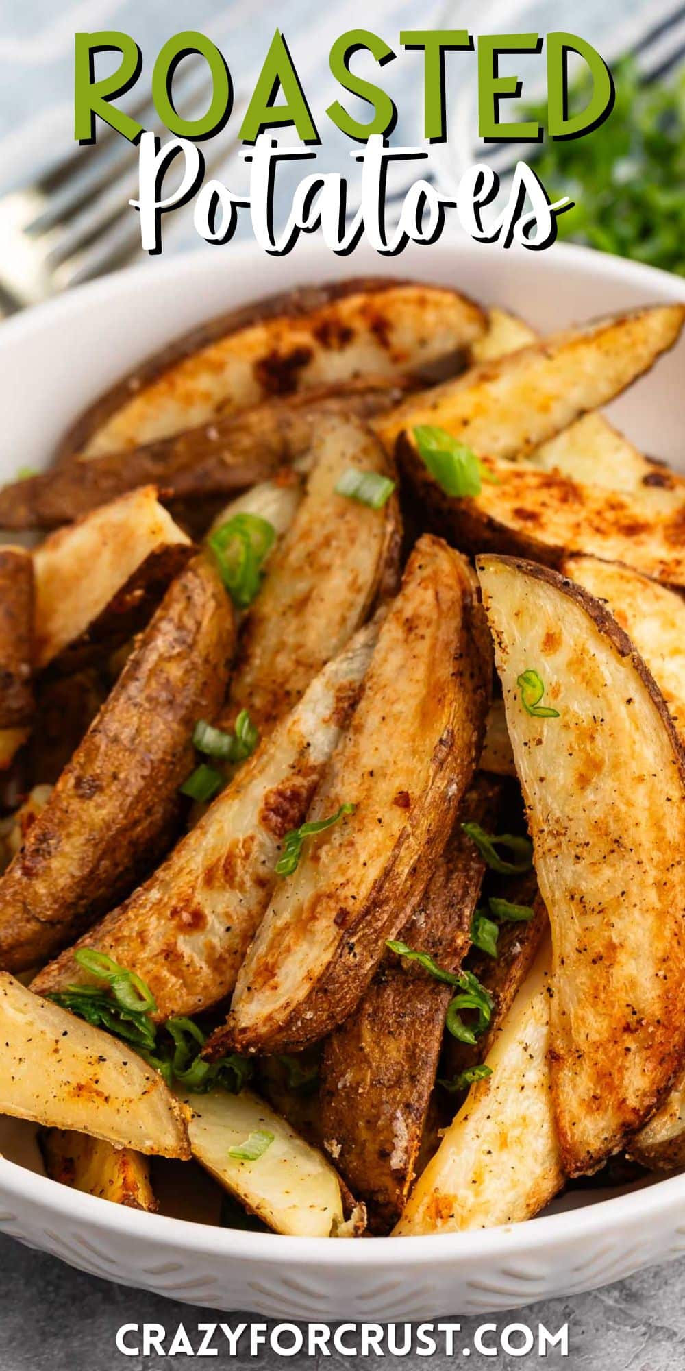 potato wedges in a white bowl with a green garnish with words on the image.