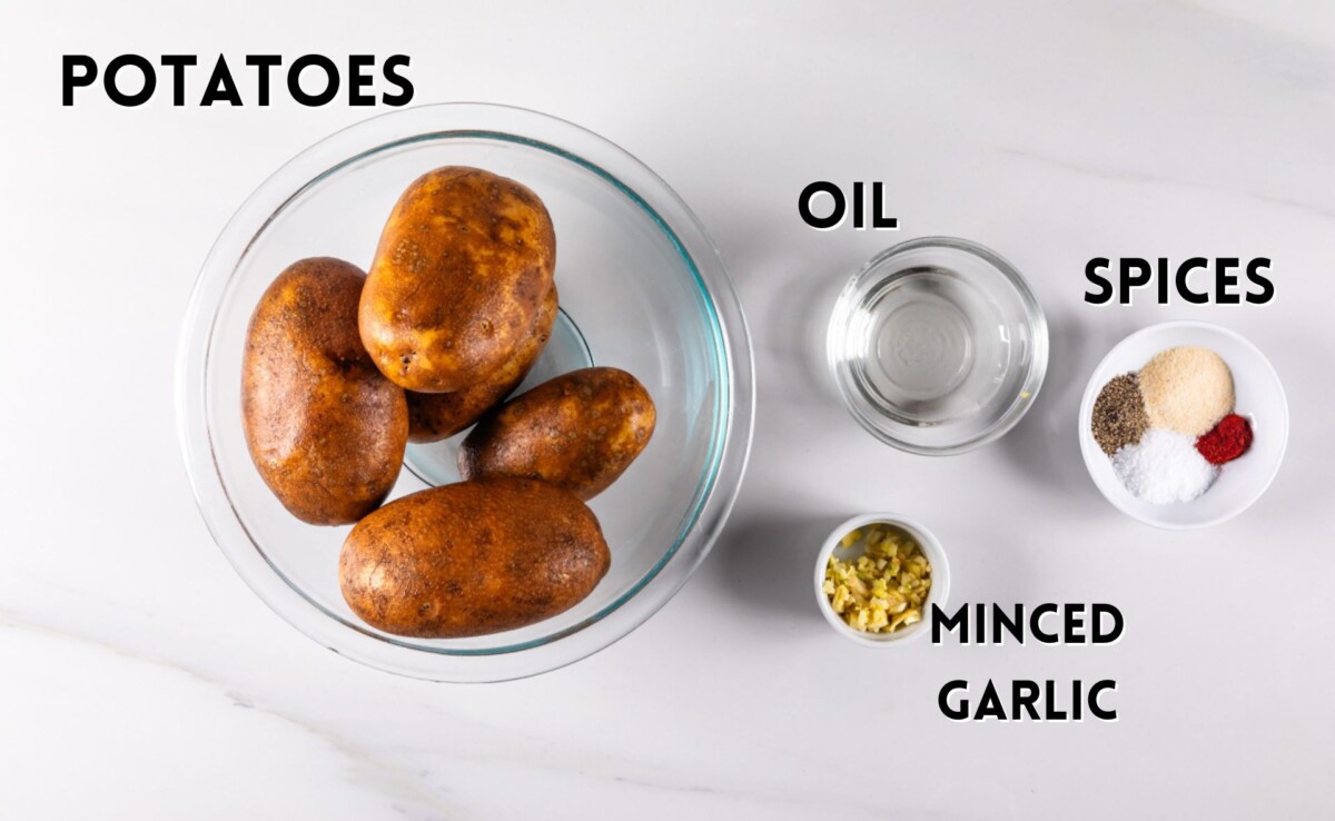 ingredients in roasted potatoes laid out on a white marble counter.