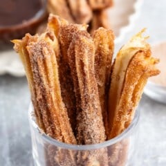 churros propped up together in a clear glass.