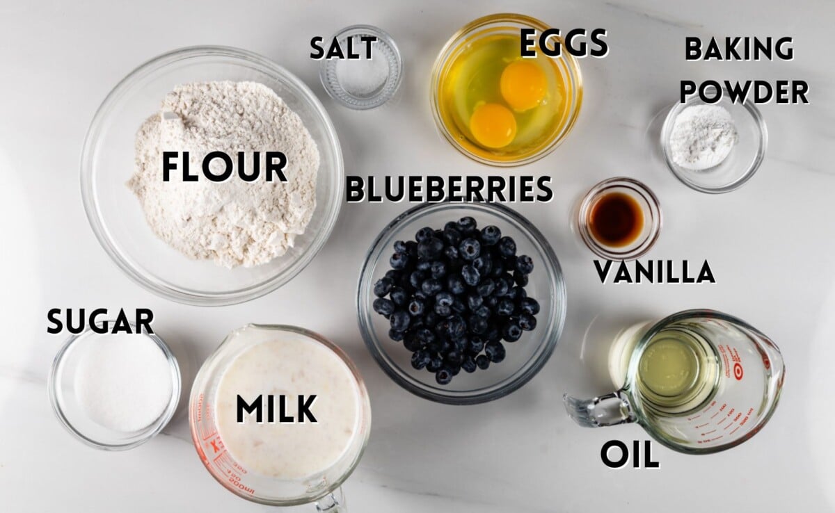 ingredients in baked blueberry pancake laid out on a white marble counter.